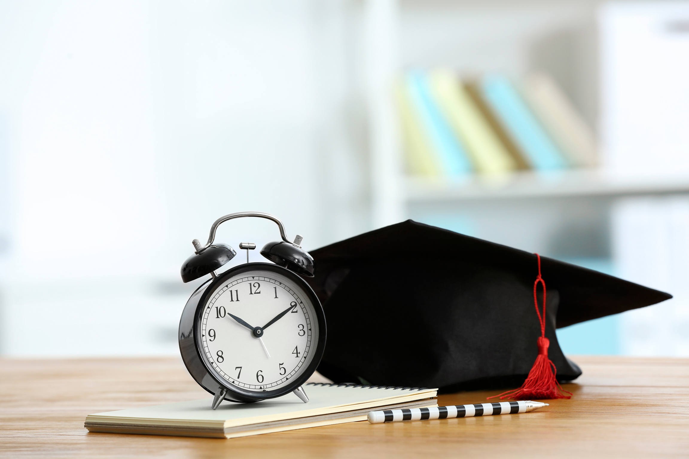 Alarm Clock and Graduation Cap on Table